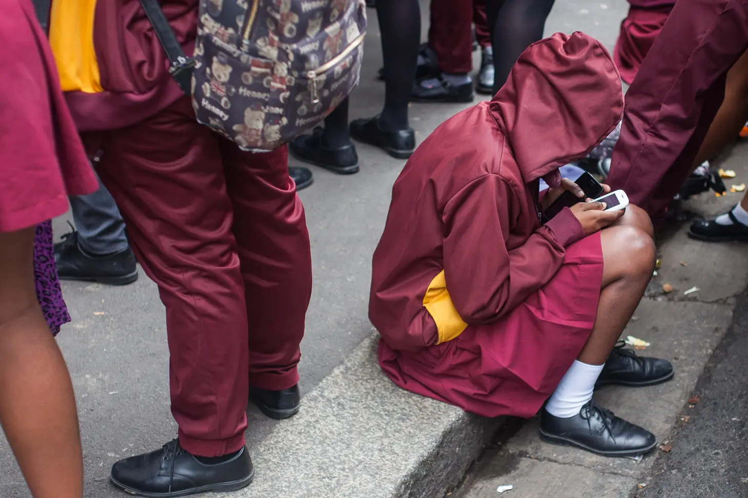 Photo of youths looking at
                                        cellphones